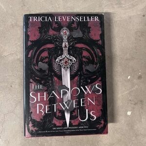 The Shadows Between Us Hardcover Book